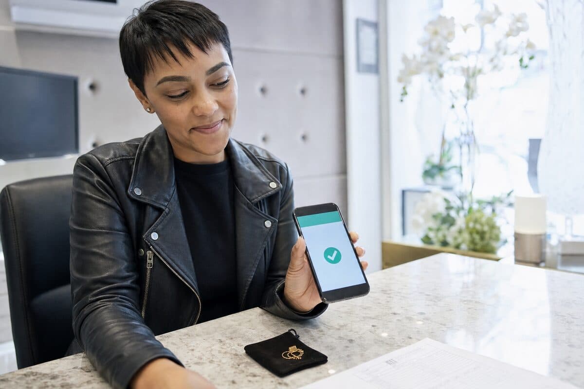 Client confirming an instant EFT payment on their phone after selling jewellery